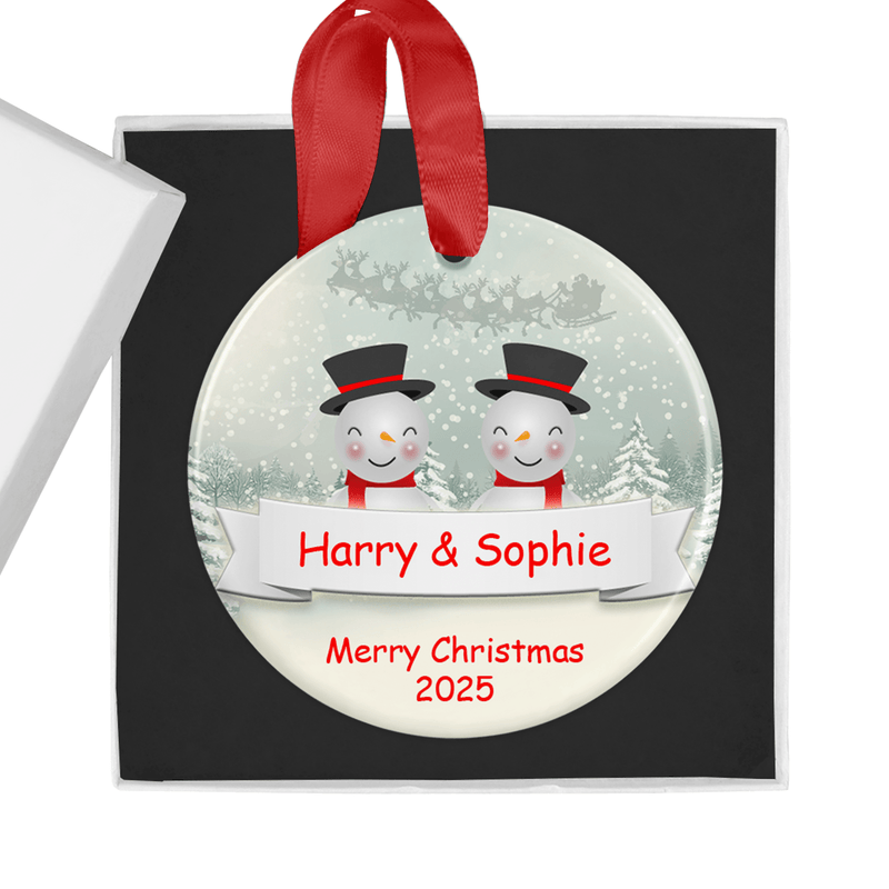 Personalised ceramic ornament with an adorable snowman couple design, complete with wintry scenery and festive details