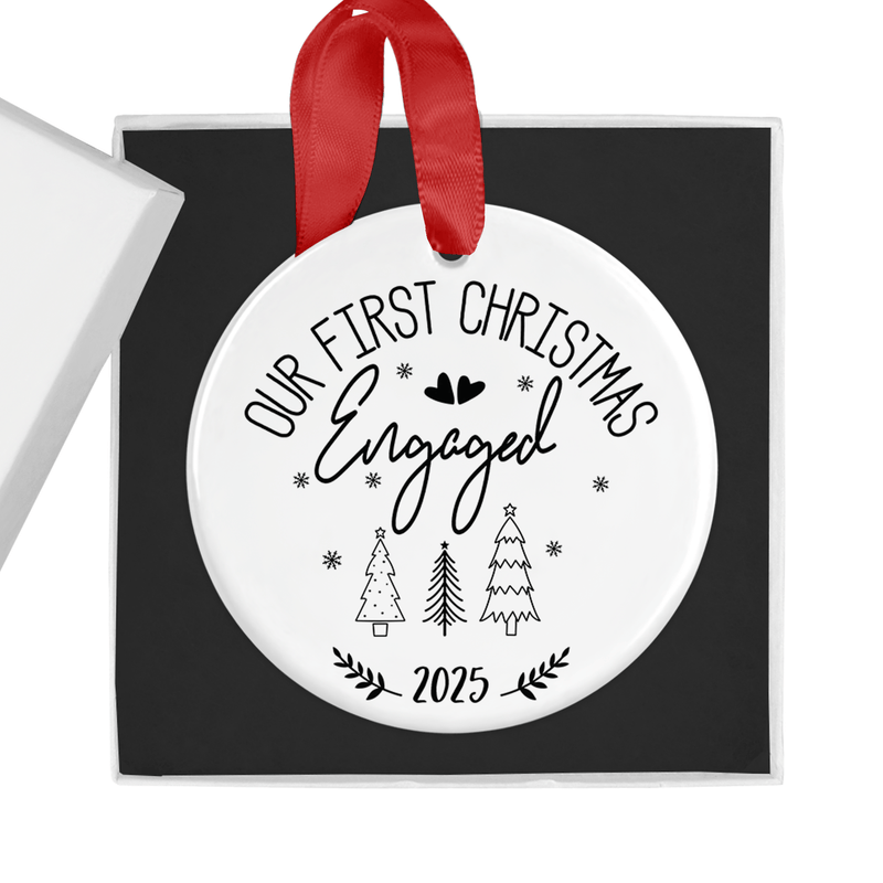 ceramic ornament with a stylish black festive design with hearts and trees, finished with a red hanging ribbon