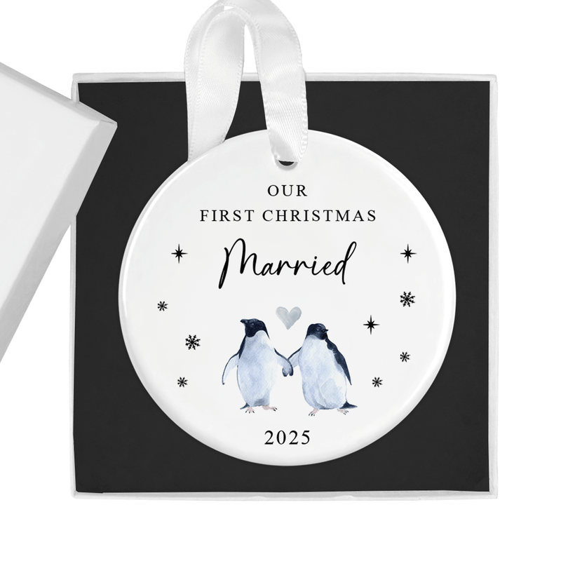 ceramic ornament with two penguins holding flippers with a heart above