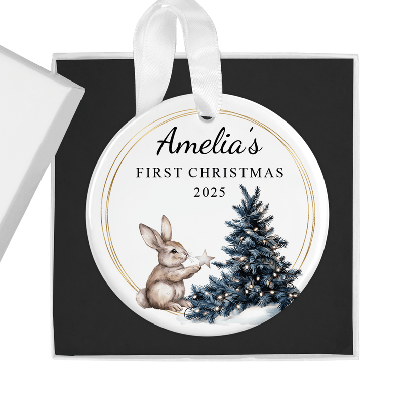 Personalised ceramic ornament with a sweet bunny holding a star beside a Christmas tree