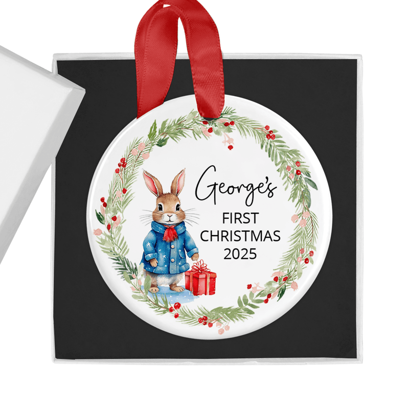 Personalised ceramic ornament with a sweet bunny in a blue winter coat, holding a festive gift