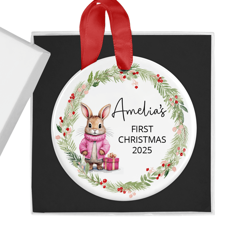 Personalised ceramic ornament with a sweet bunny in a pink winter coat, holding a festive gift