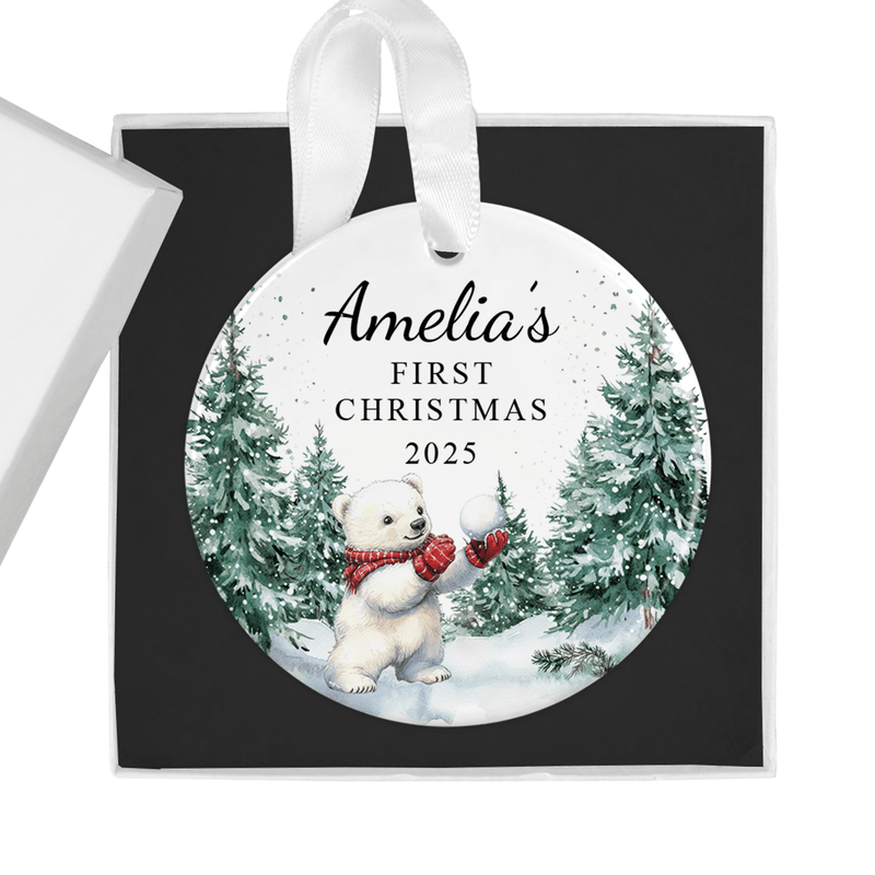 Personalised ceramic ornament with an adorable polar bear cub in red mittens, holding a snowball in a snowy forest