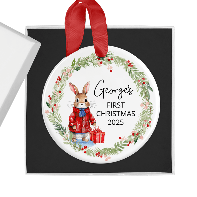 Personalised ceramic ornament with a sweet bunny in a red winter coat, holding a festive gift