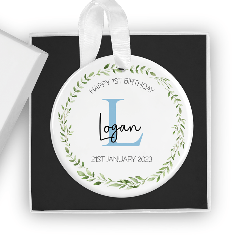 Personalised ceramic ornament with a green leaf wreath, blue initial, name and date