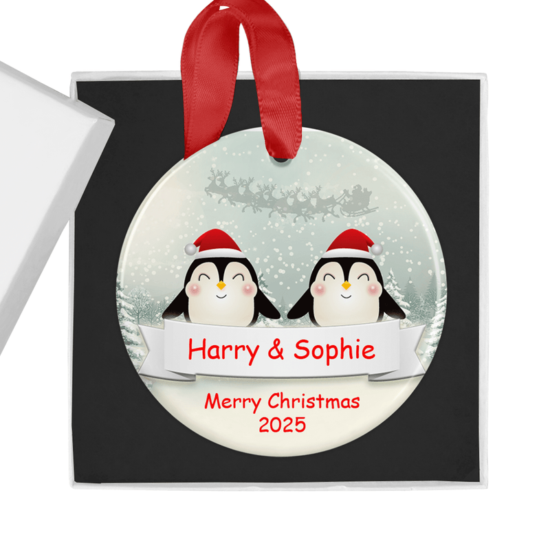Personalised ceramic ornament with a sweet penguin couple design wearing festive Santa hats