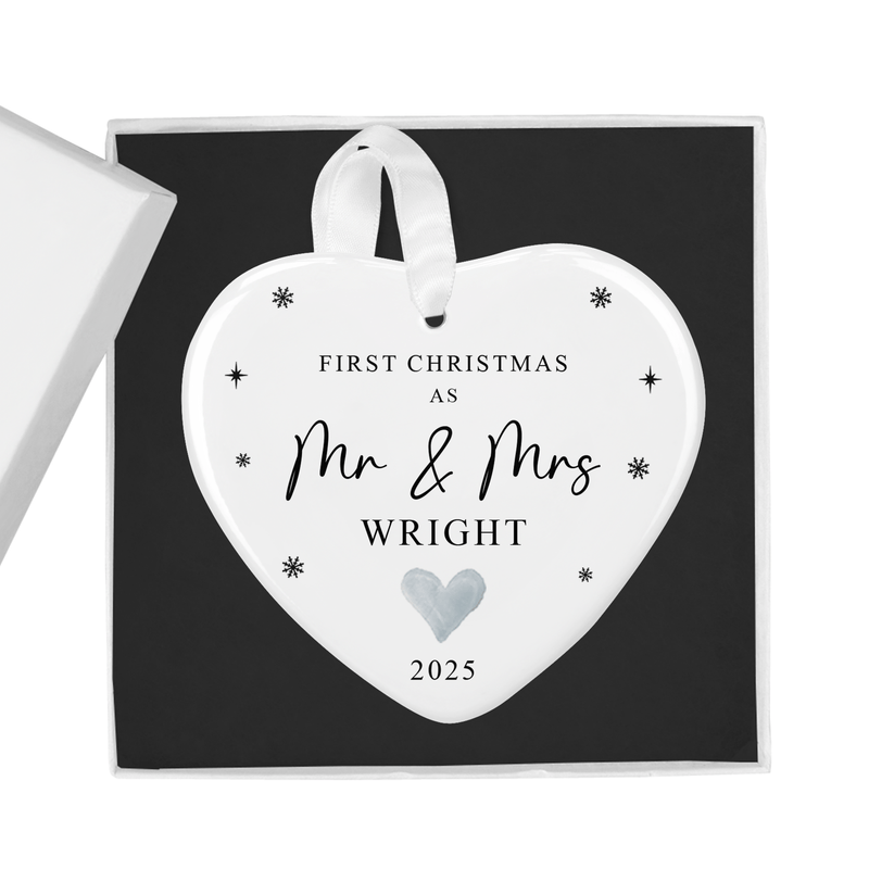 Personalised ceramic ornament with your shared surname, delicate snowflake accents
