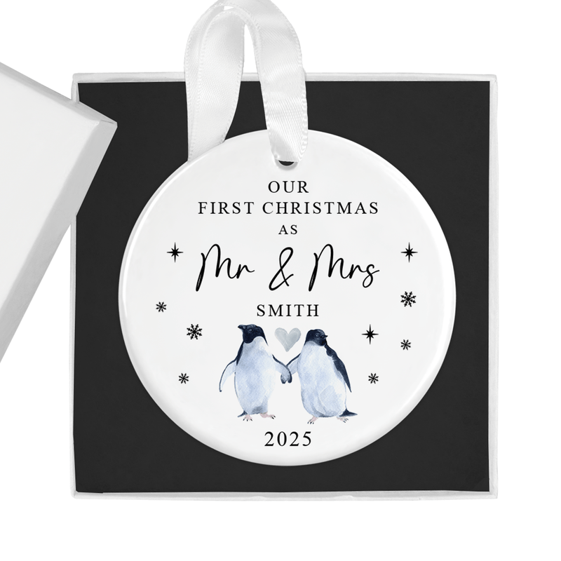 Personalised ceramic ornament with two penguins holding flippers beneath a heart