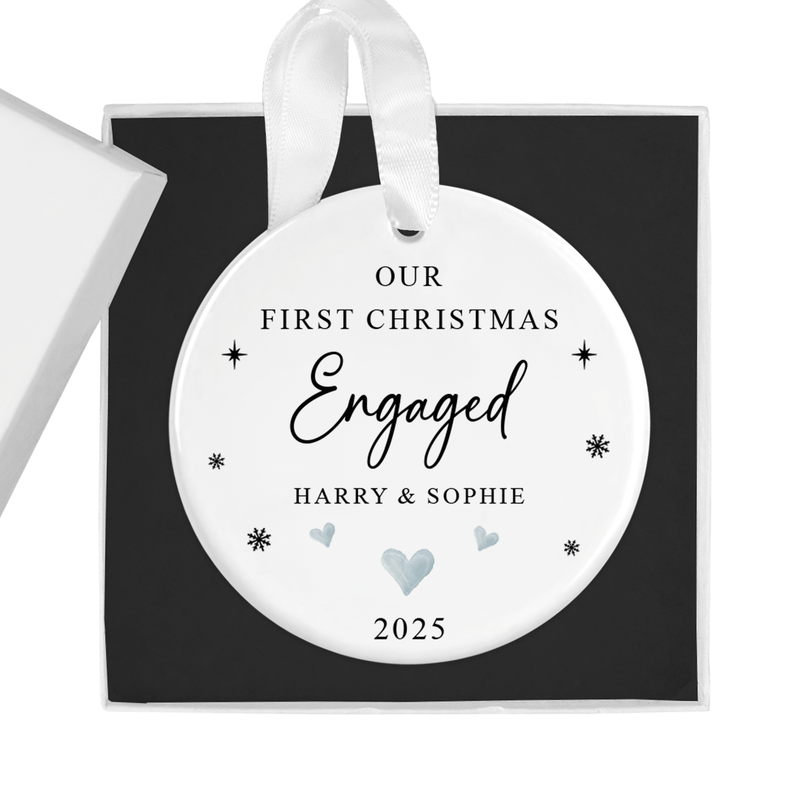 Personalised ceramic ornament with a first christmas engaged artwork