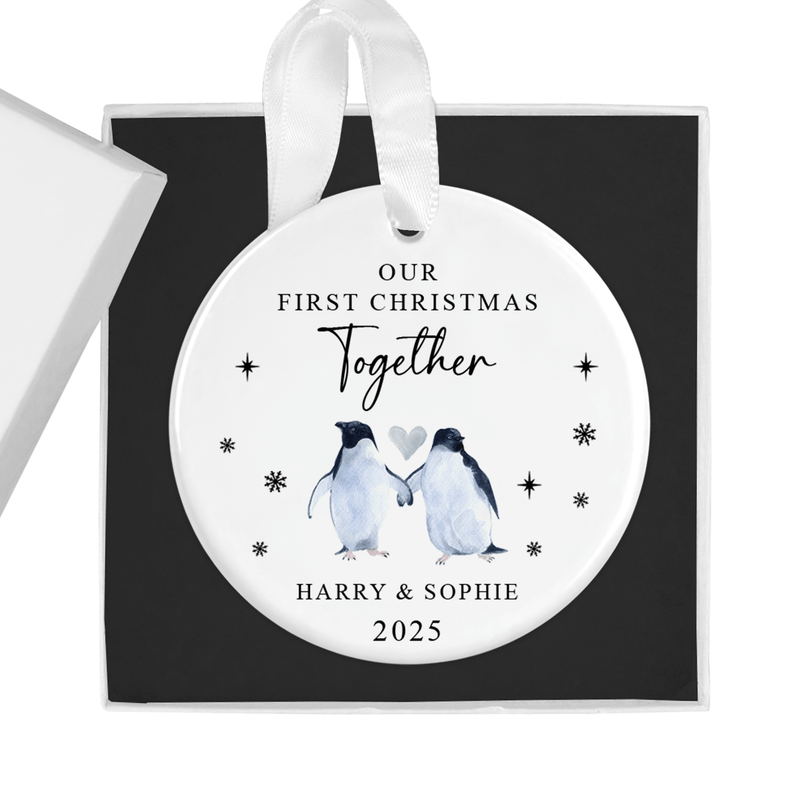 Personalised ceramic ornament with two penguins holding flippers beneath a heart