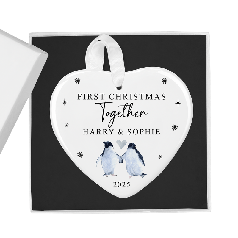 Personalised ceramic ornament with a sweet hand-painted style illustration of two penguins holding a heart