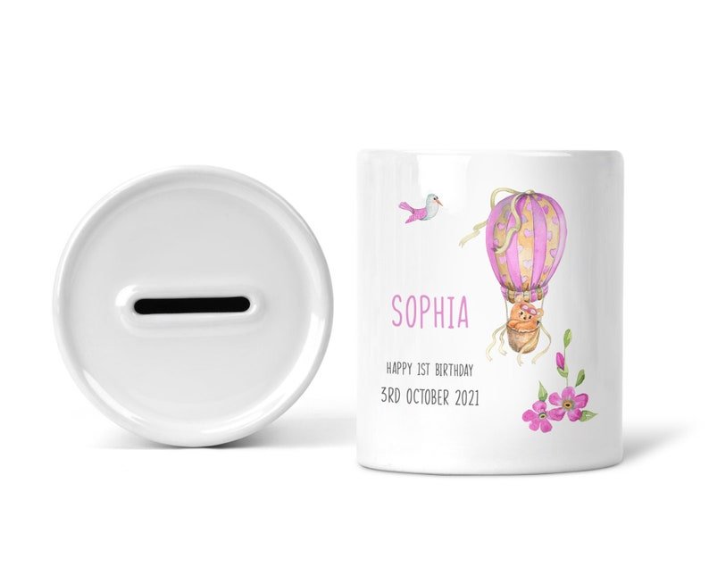 Personalised Pink Hot Air Balloon 1st Birthday Money Box shown as a ceramic keepsake