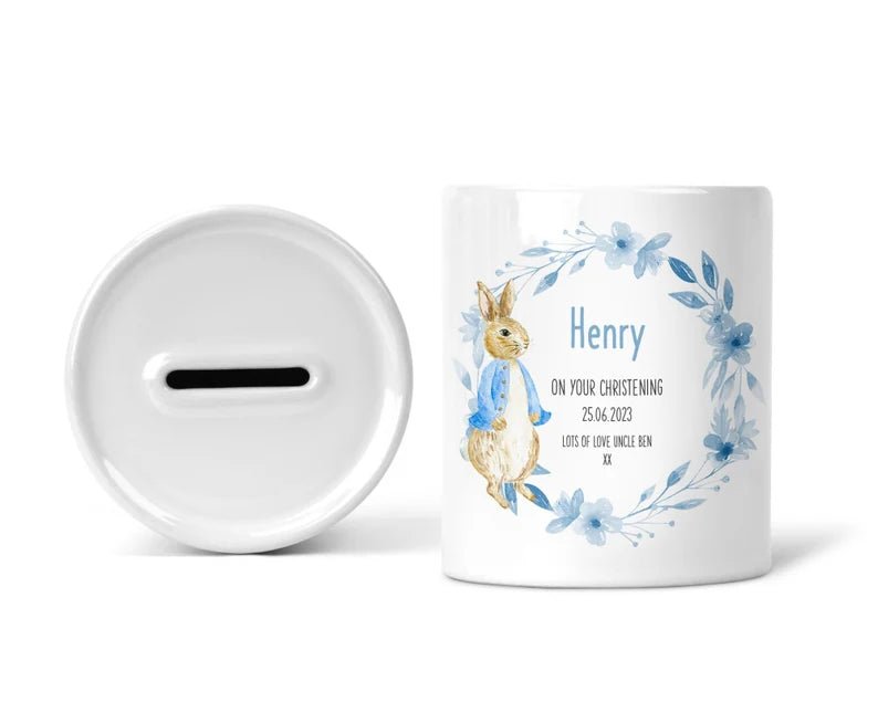 Personalised Blue Bunny Wreath Christening Money Box shown as a ceramic keepsake