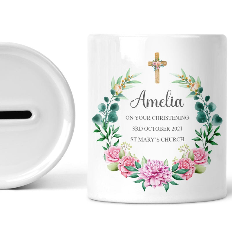 Personalised Floral Cross Christening Money Box shown as a ceramic keepsake