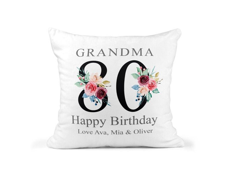 Personalised Nanny 80th Birthday Cushion with Names showing a floral milestone design front view