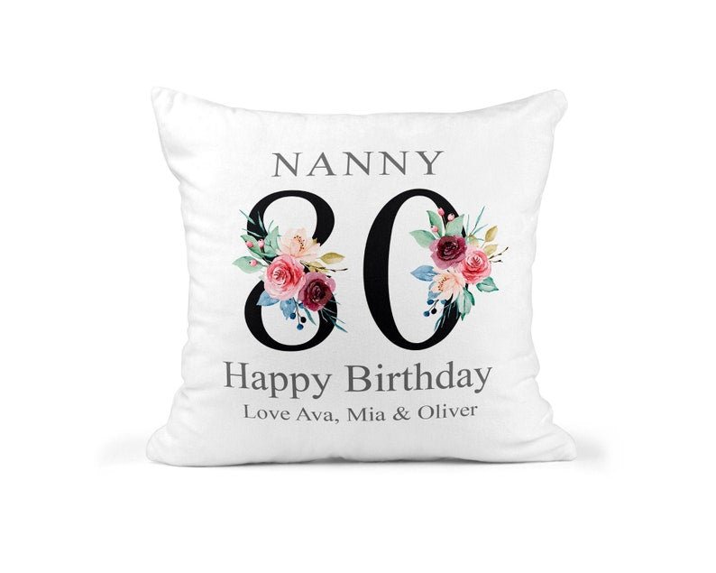 Personalised Nanny 80th Birthday Cushion with Names showing a floral milestone design front view