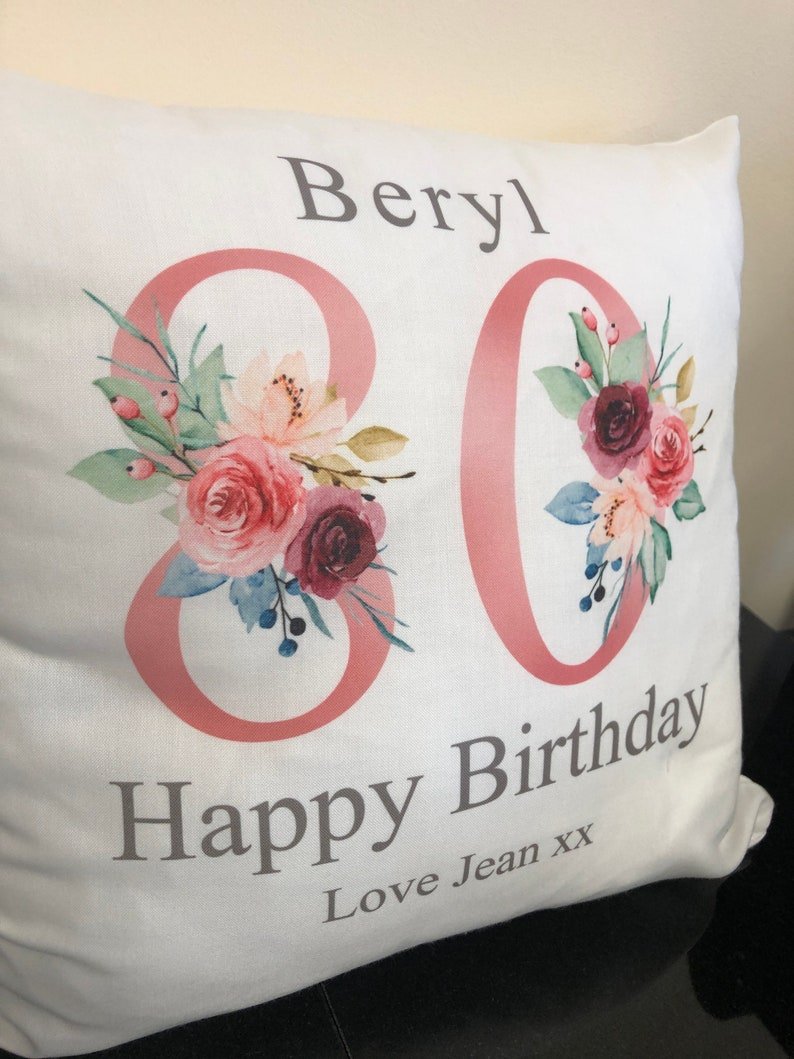 Personalised Grandma 80th Birthday Cushion with Names showing a floral milestone design styled view